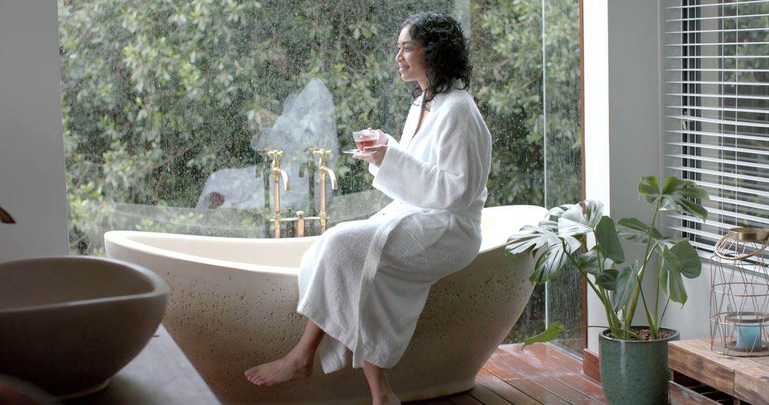 Woman Relaxing In Bathtub Near Window With Rain View - Free Images, Stock Photos and Pictures on Pikwizard.com