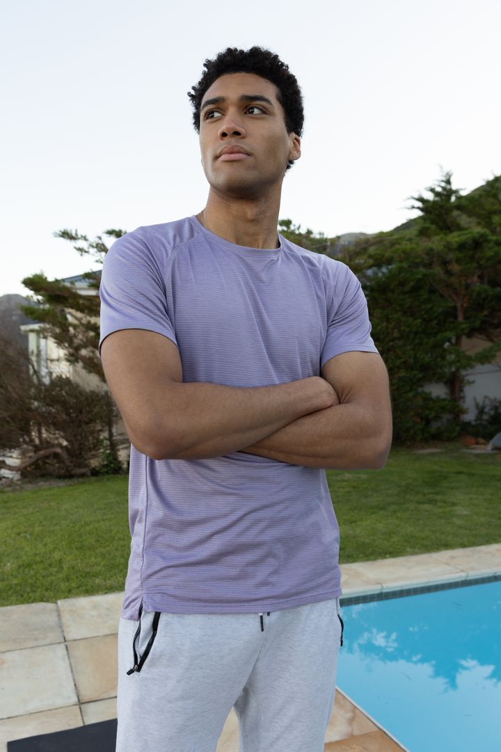 African American Man Relaxing by Poolside in Modern Backyard Setting
