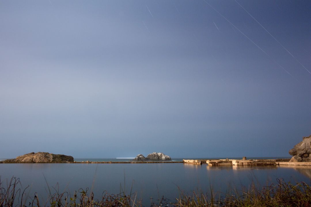 Tranquil Night at Rocky Shoreline with Clear Night Sky - Free Images, Stock Photos and Pictures on Pikwizard.com