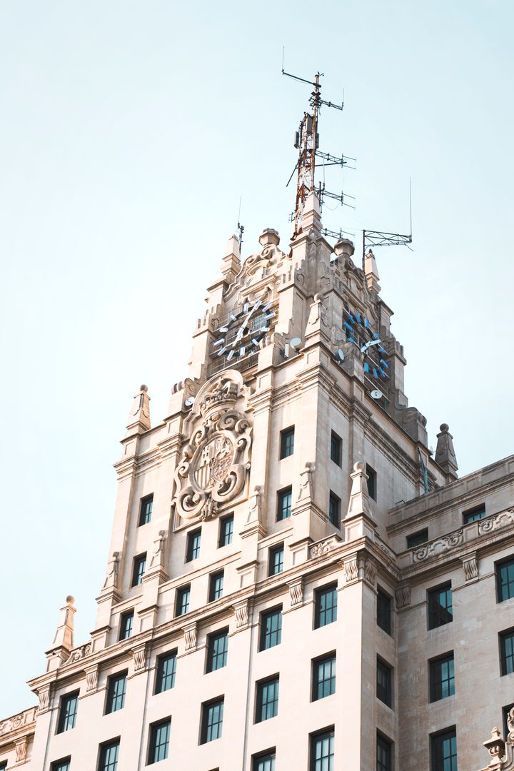 Historic Building with Ornate Clock Tower and Antennas