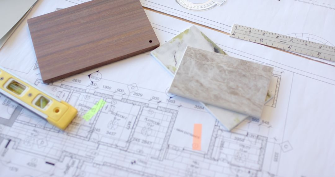 Architectural Blueprints with Building Material Samples and Tools