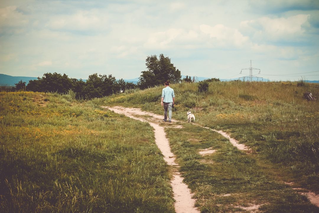 Man Walking Dog on Rural Path in Countryside - Free Images, Stock Photos and Pictures on Pikwizard.com