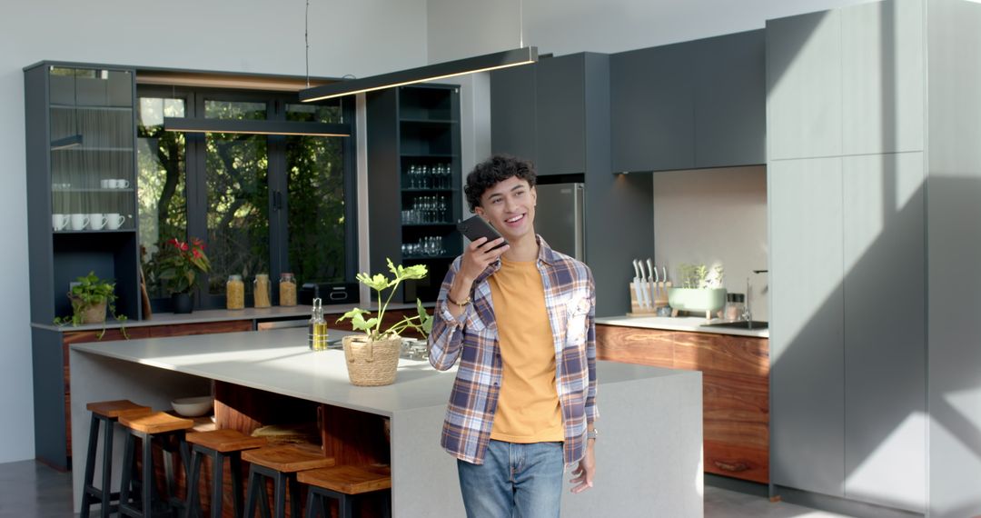 Man Engaging on Smartphone in Stylish Modern Kitchen