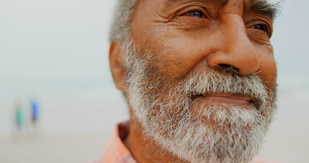 Thoughtful Senior Man with Beach Background, Close-up Portrait Shot