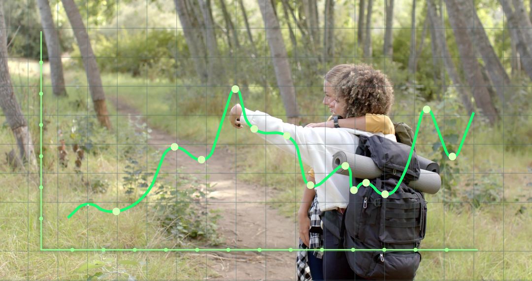Hikers pointing along woodland trail with large backpack and rolled mat, analytics grid overlay