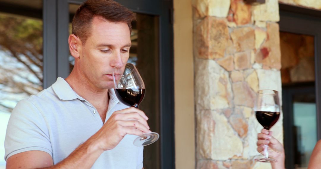 Man Savoring a Glass of Red Wine on a Patio - Free Images, Stock Photos and Pictures on Pikwizard.com