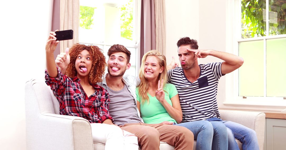 Group of Friends Taking a Funny Selfie on a Sofa in a Bright Living Room - Free Images, Stock Photos and Pictures on Pikwizard.com