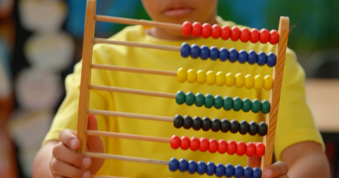 Child Engaging with Colorful Abacus in Classroom Learning