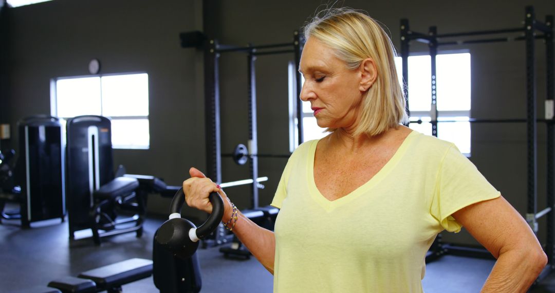 Senior Woman Exercising with Kettlebell in Gym - Free Images, Stock Photos and Pictures on Pikwizard.com