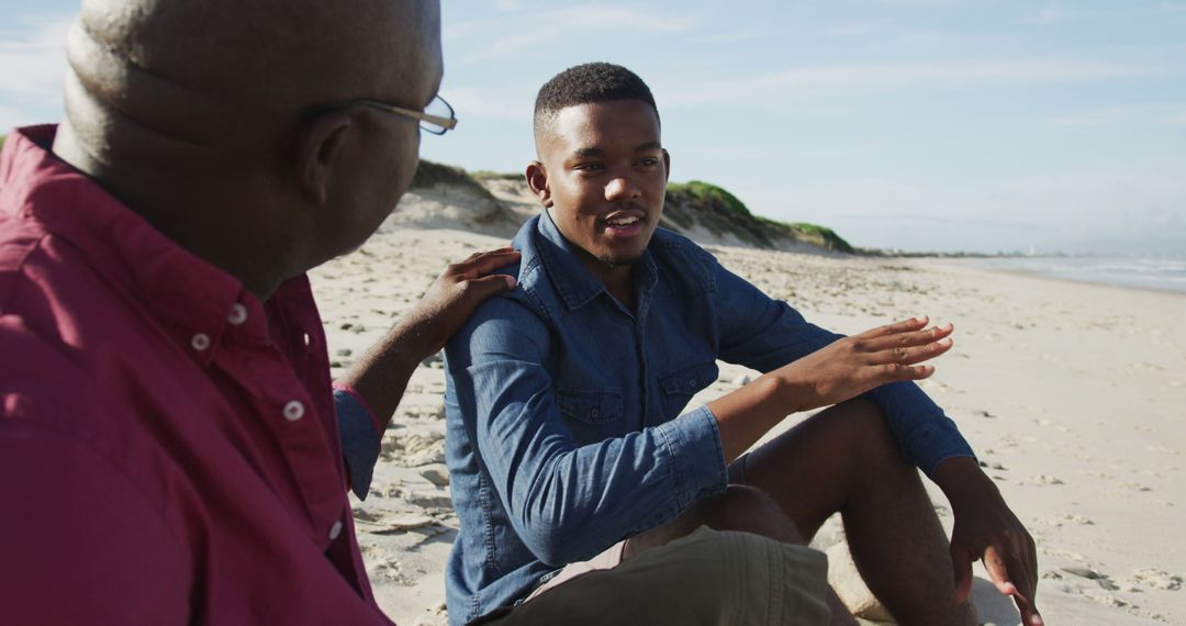 Two Men Having a Meaningful Conversation on Beach - Free Images, Stock Photos and Pictures on Pikwizard.com