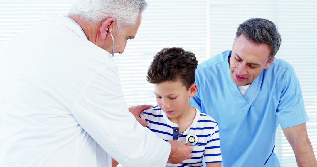 Pediatrician Checking Young Boy's Heartbeat with Nurse Assisting - Free Images, Stock Photos and Pictures on Pikwizard.com