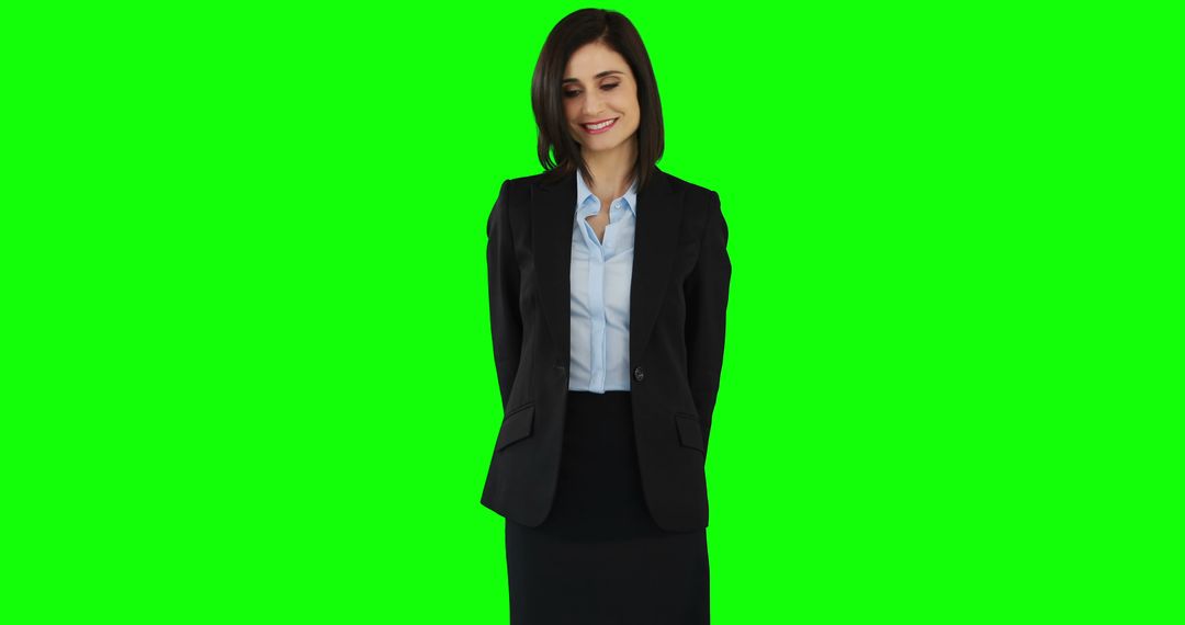 Professional Woman in Business Suit Standing Against Green Background - Free Images, Stock Photos and Pictures on Pikwizard.com