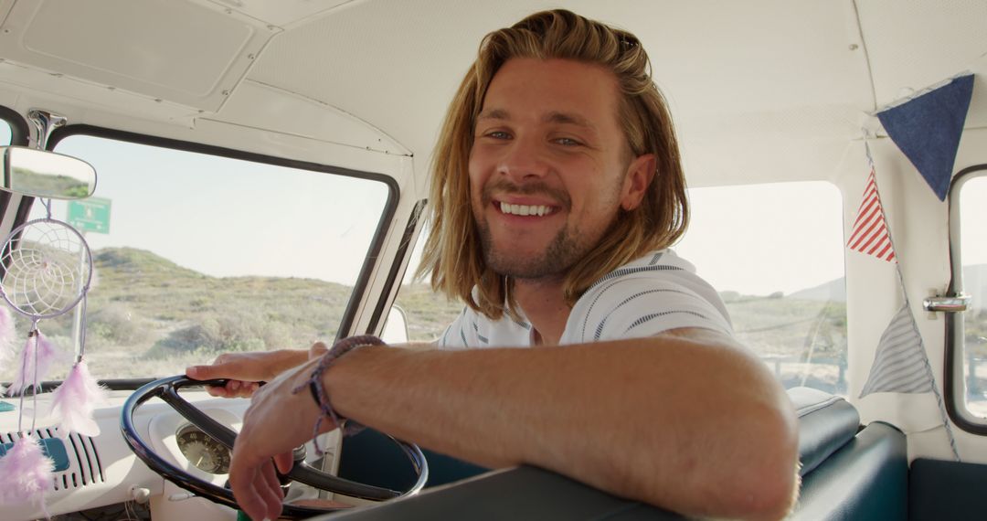 smiling man enjoying road trip in vintage campervan - Free Images, Stock Photos and Pictures on Pikwizard.com