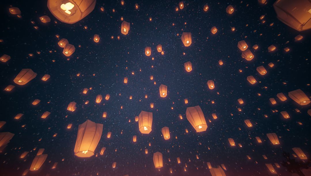 Lanterns Illuminating Night Sky with Starry Backdrop