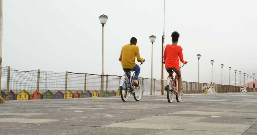 Couple Riding Bicycles on Modern Promenade - Free Images, Stock Photos and Pictures on Pikwizard.com