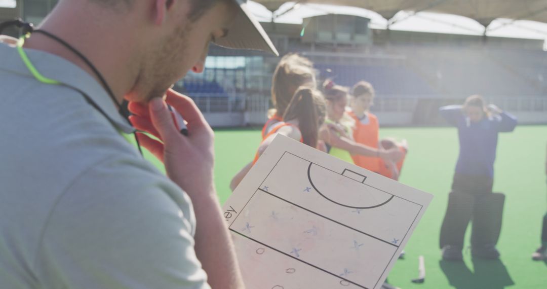 Field Hockey Coach Discussing Strategies with Team - Free Images, Stock Photos and Pictures on Pikwizard.com