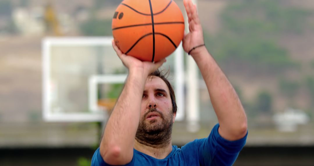 Young Man Concentrating on Shooting Basketball Outdoors - Free Images, Stock Photos and Pictures on Pikwizard.com