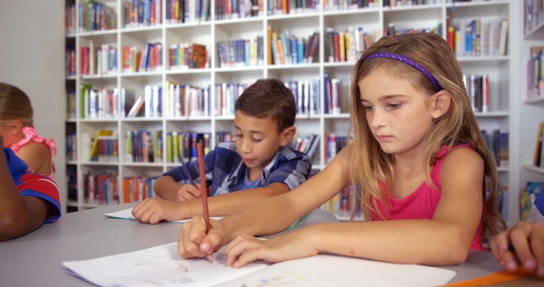 Children Studying in Library with Bookshelves in Background - Free Images, Stock Photos and Pictures on Pikwizard.com