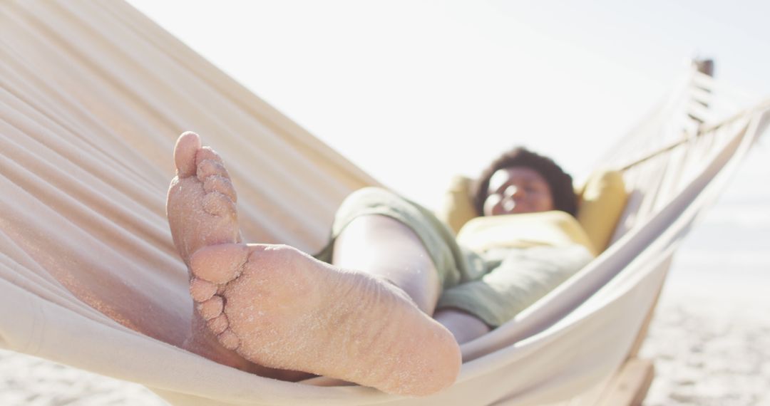 Relaxed Person Lounging in Hammock on Beach - Free Images, Stock Photos and Pictures on Pikwizard.com