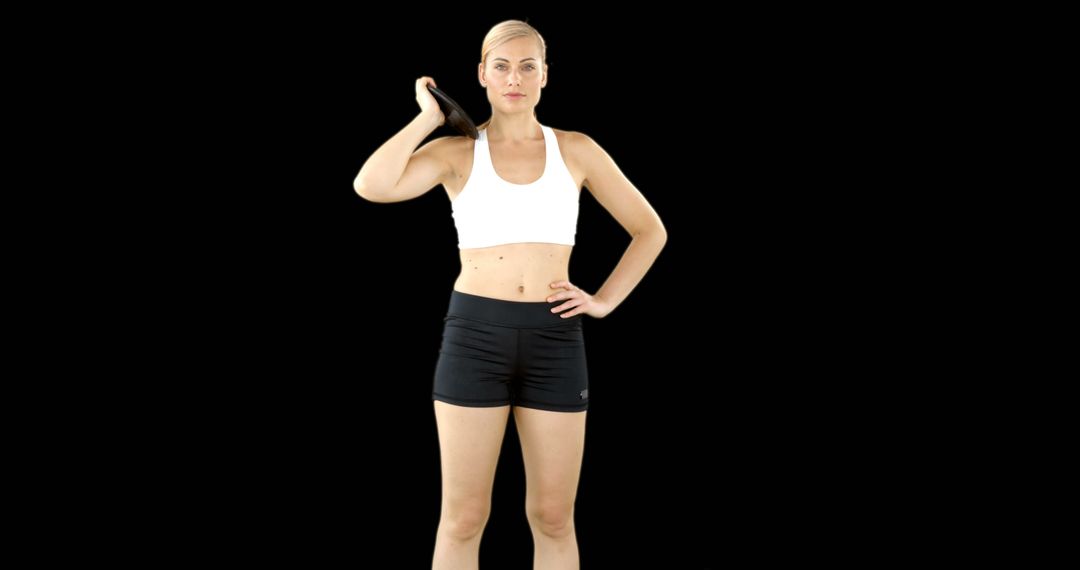 Fit woman exercising with kettlebell on black background - Free Images, Stock Photos and Pictures on Pikwizard.com