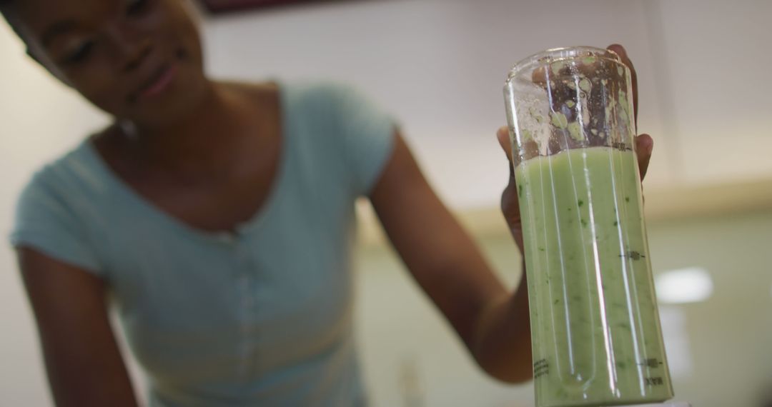 Woman Making Green Smoothie in Blender at Home Kitchen - Free Images, Stock Photos and Pictures on Pikwizard.com