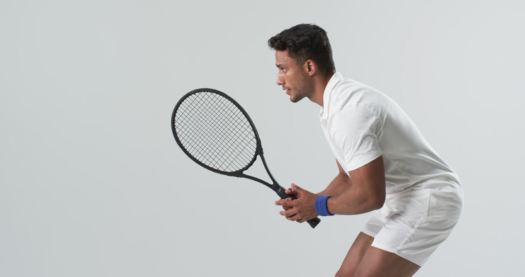 Focused Tennis Player Preparing to Serve on Neutral Background