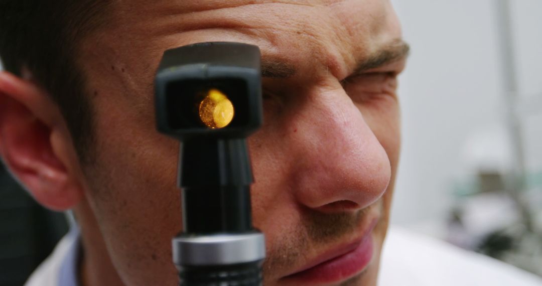 Optometrist Examining Eyes with Ophthalmoscope for Vision Check - Free Images, Stock Photos and Pictures on Pikwizard.com