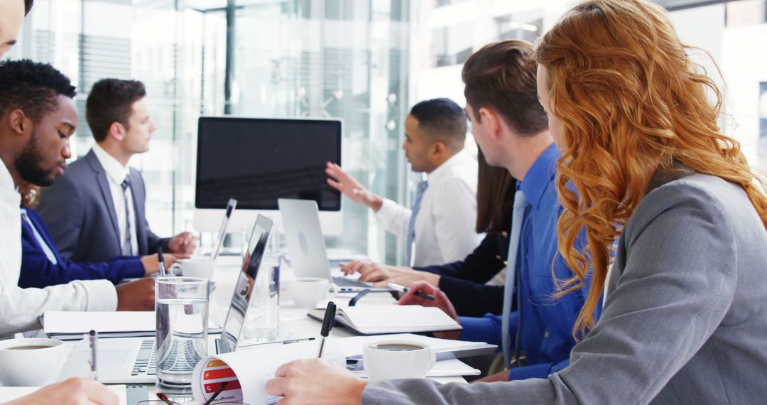 Team Engaged in Online Presentation at Conference Room