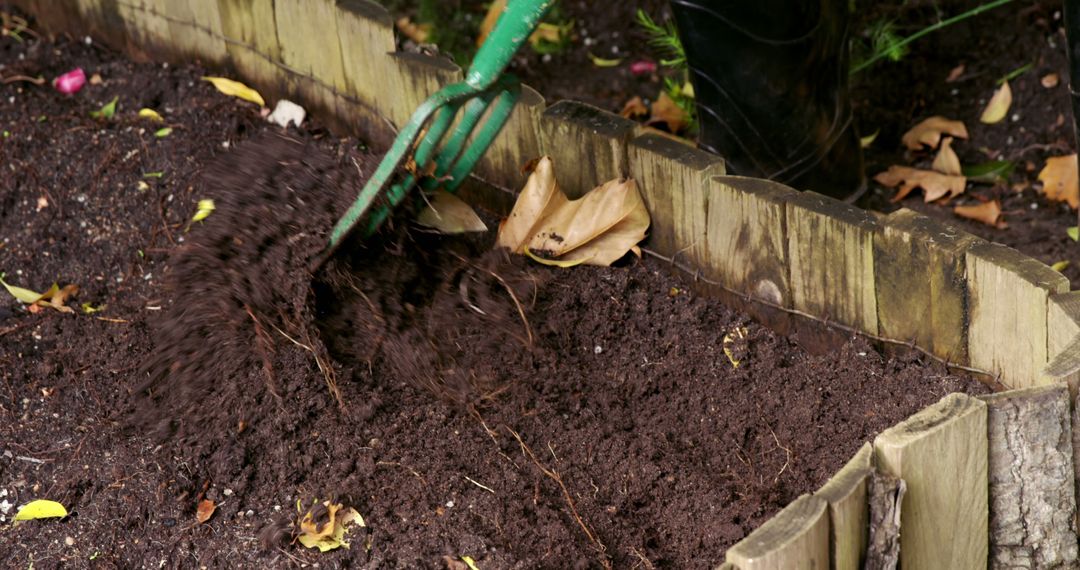 Gardener Tilling Soil in Backyard Garden Bed - Free Images, Stock Photos and Pictures on Pikwizard.com