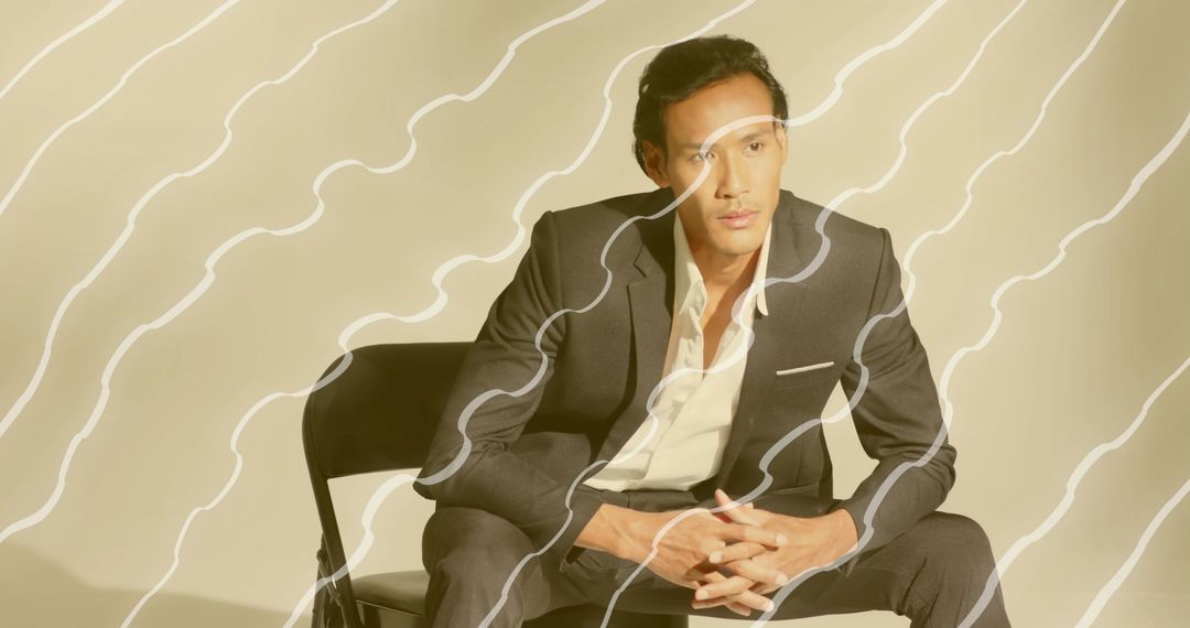 Confident Asian Man in Suit with Modern Abstract Overlay Design