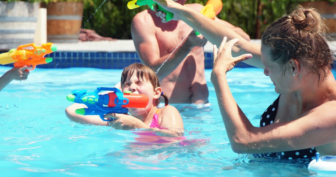 Family Enjoying Fun Pool Water Gun Battle on Sunny Day - Free Images, Stock Photos and Pictures on Pikwizard.com