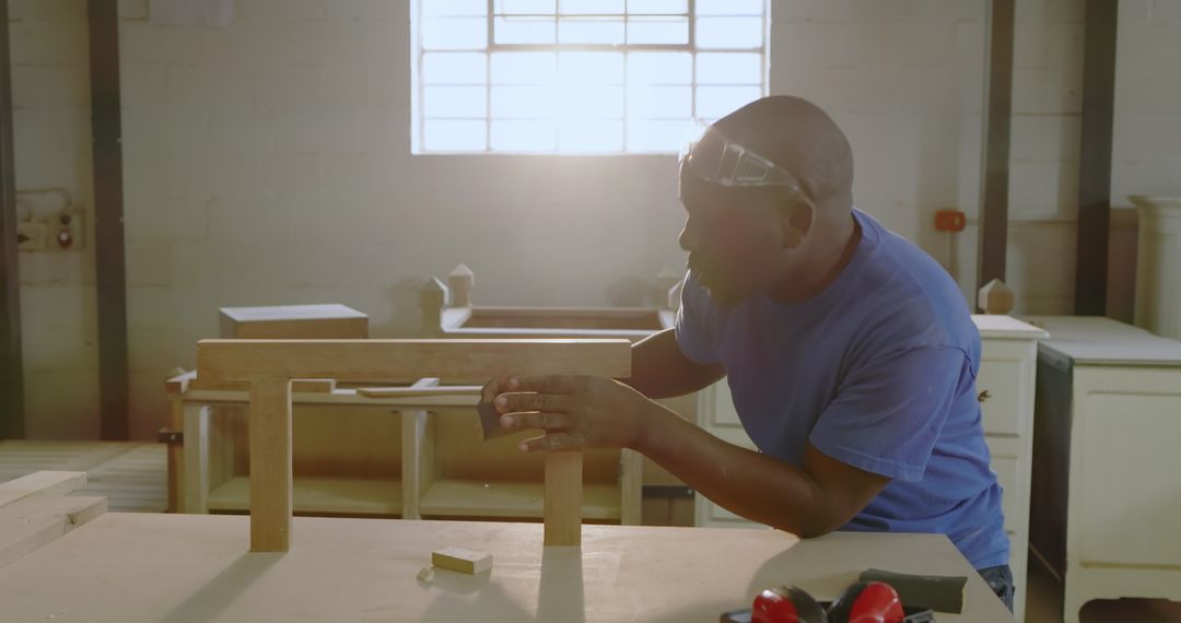 Artisan Skillfully Constructs Wooden Beam Support in Workshop