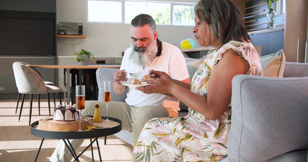 Senior Couple Celebrating with Cake and Drinks at Home