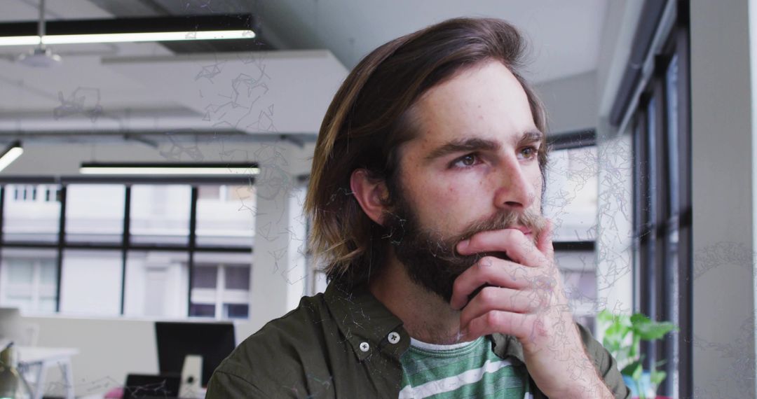 Thoughtful Professional in Modern Office Environment