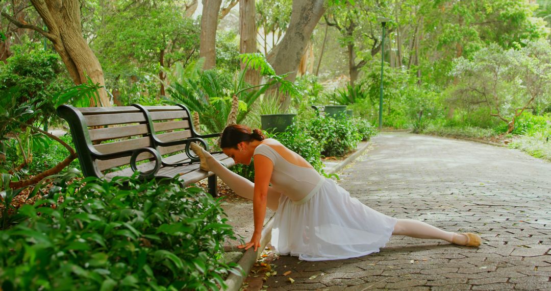 Female ballerina doing stretching exercise in the park - Free Images, Stock Photos and Pictures on Pikwizard.com