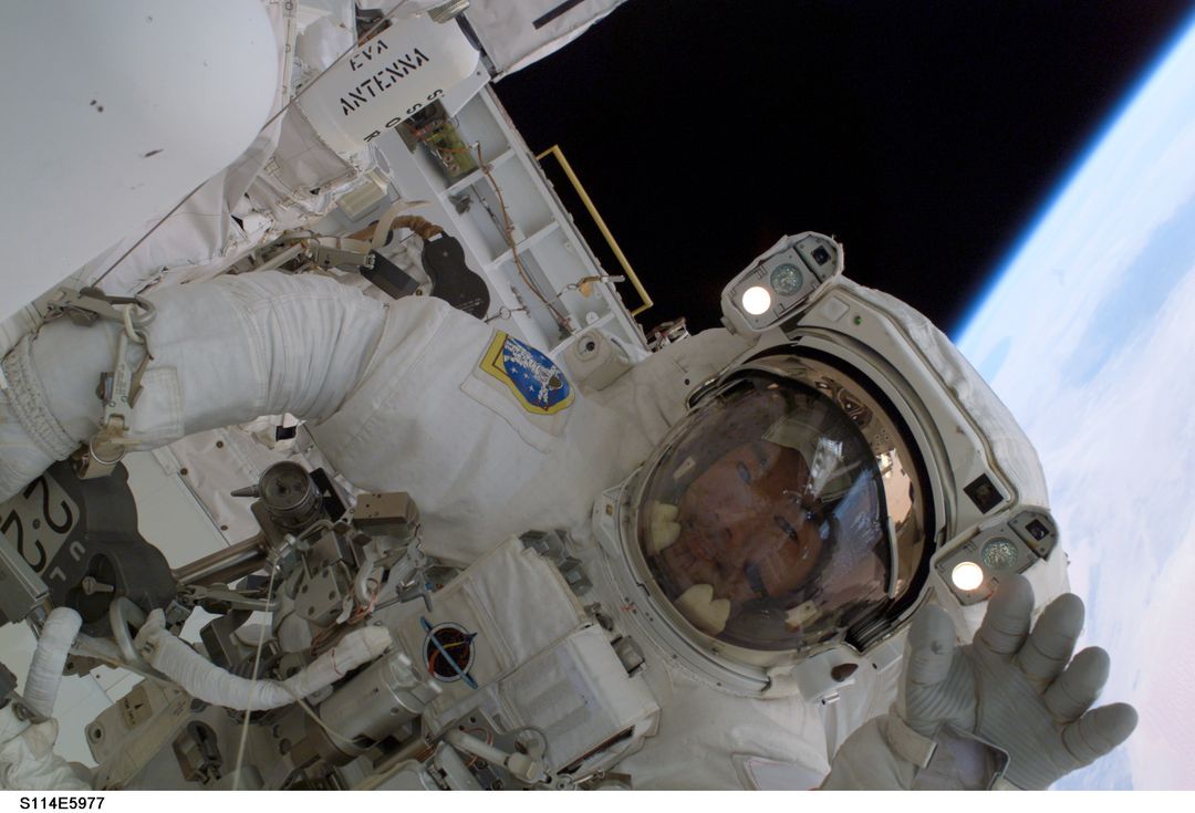 Astronaut Noguchi Waves during Spacewalk Above Earth Horizon - Free Images, Stock Photos and Pictures on Pikwizard.com