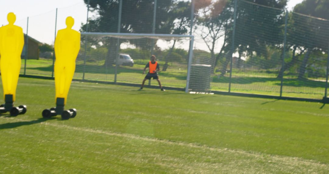 Goalkeeper Practicing Defending Goals on Soccer Field With Dummy Players - Free Images, Stock Photos and Pictures on Pikwizard.com