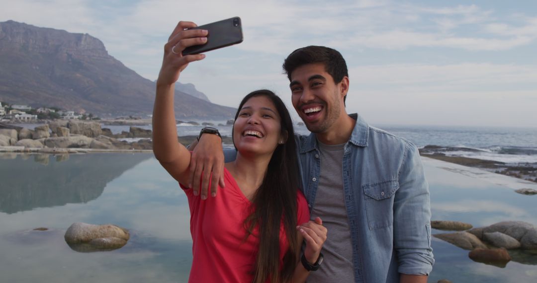 Happy Couple Taking Selfie by Scenic Ocean View - Free Images, Stock Photos and Pictures on Pikwizard.com