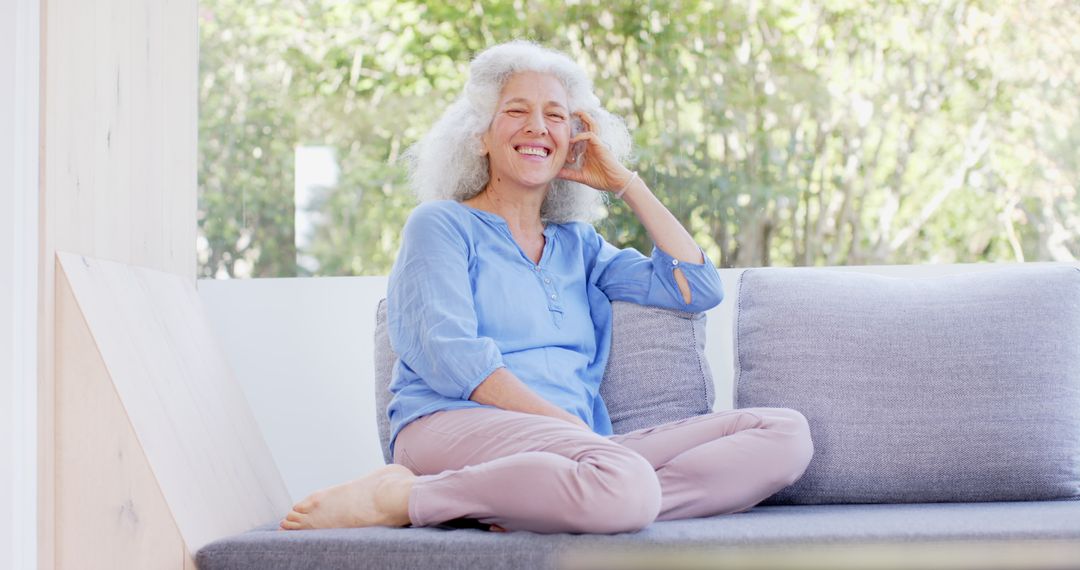 Senior Woman Relaxing on Sofa Smiling Joyful Lifestyle