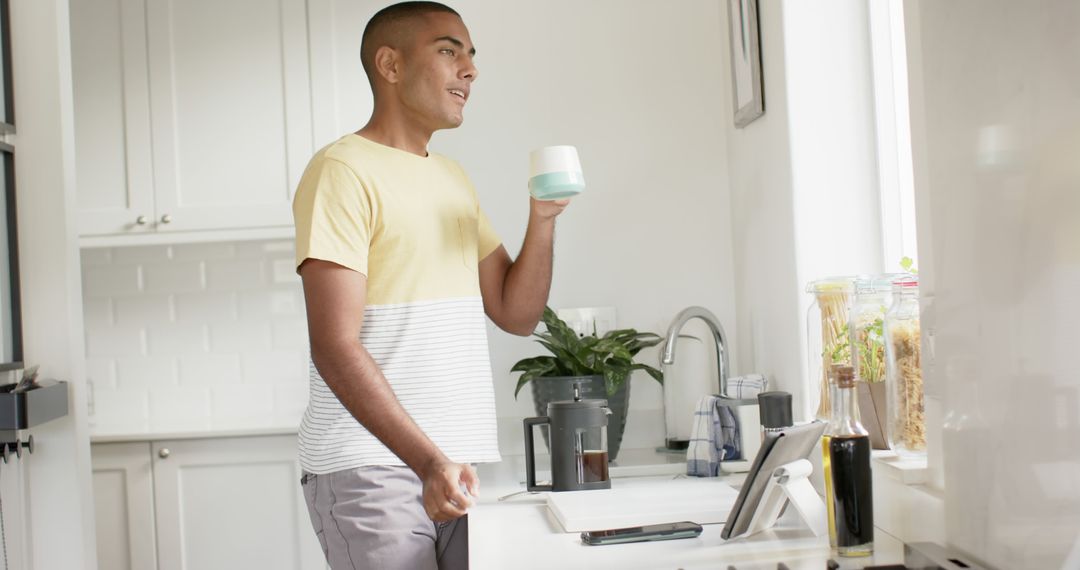 Man Having Breakfast and Enjoying Morning Beverage in Modern Kitchen - Free Images, Stock Photos and Pictures on Pikwizard.com