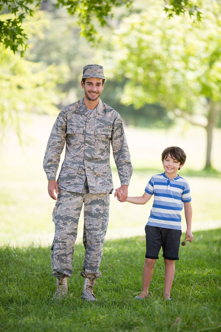 Army Soldier Holding Hands with Son in Park - Free Images, Stock Photos and Pictures on Pikwizard.com