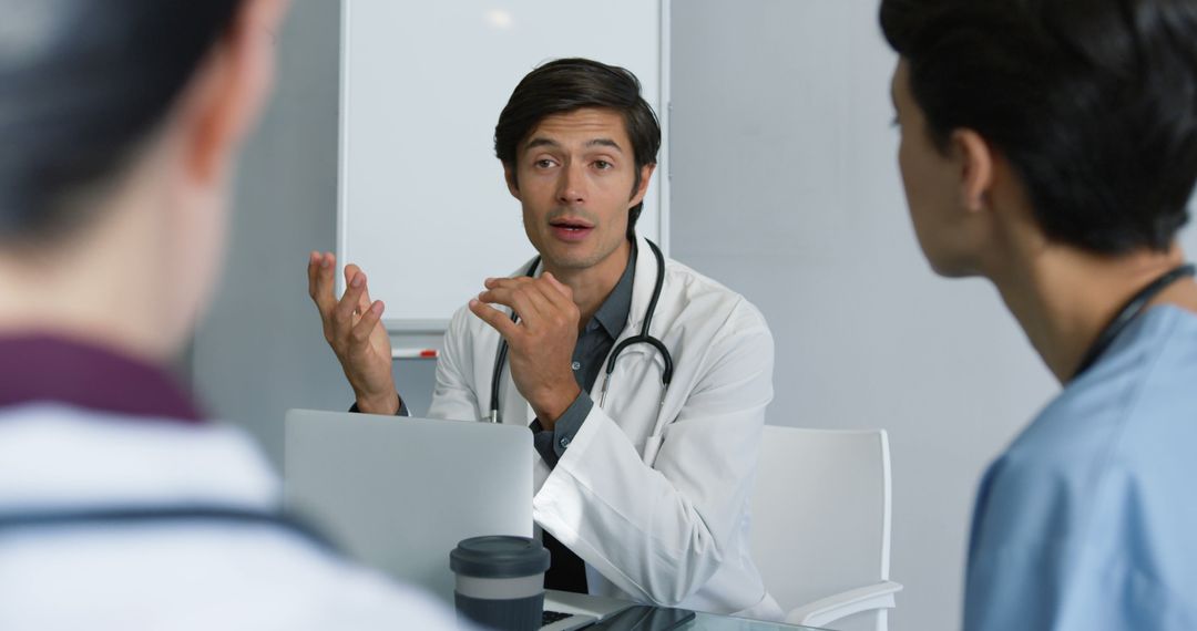 Doctor Leading Team Meeting in Medical Office - Free Images, Stock Photos and Pictures on Pikwizard.com