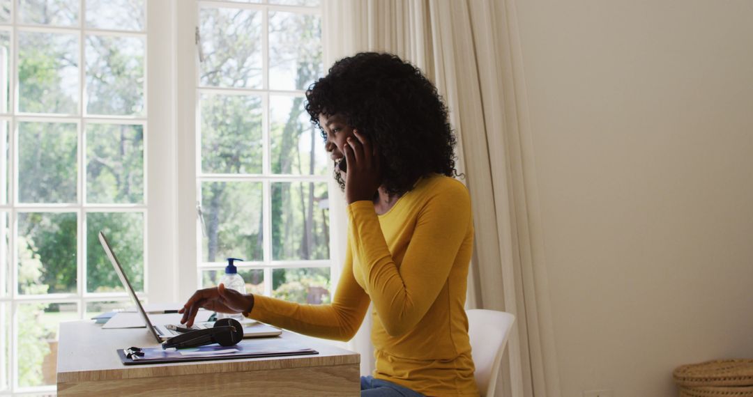 African American woman working from home using laptop and smartphone - Free Images, Stock Photos and Pictures on Pikwizard.com