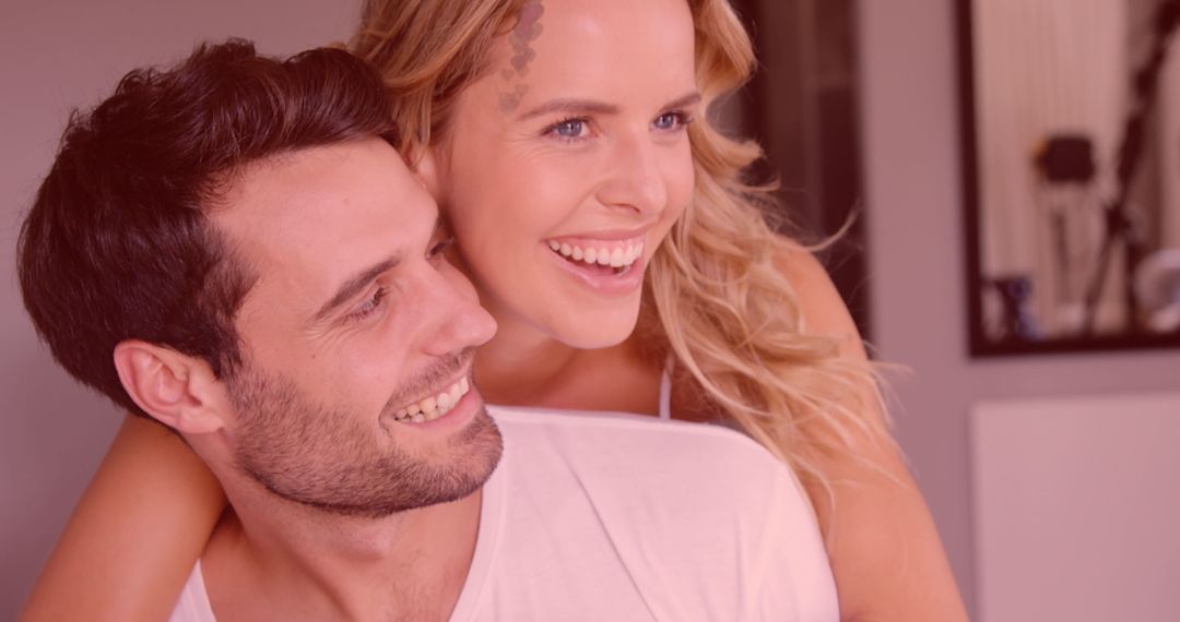 Joyful Couple Embracing with Romantic Heart Overlay