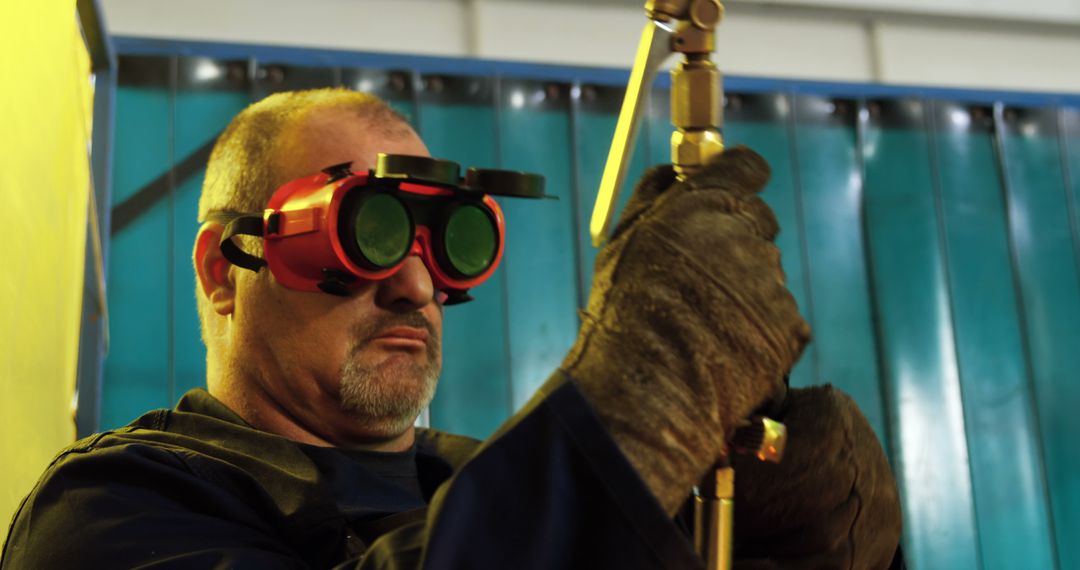 Industrial Worker Using Welding Equipment in Factory Setting - Free Images, Stock Photos and Pictures on Pikwizard.com