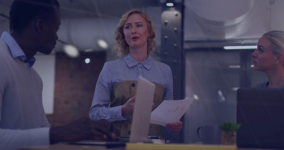 Diverse Business Meeting In Corporate Office With Financial Data Overlay