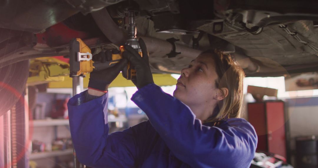 Female Mechanic Repairing Vehicle in Workshop