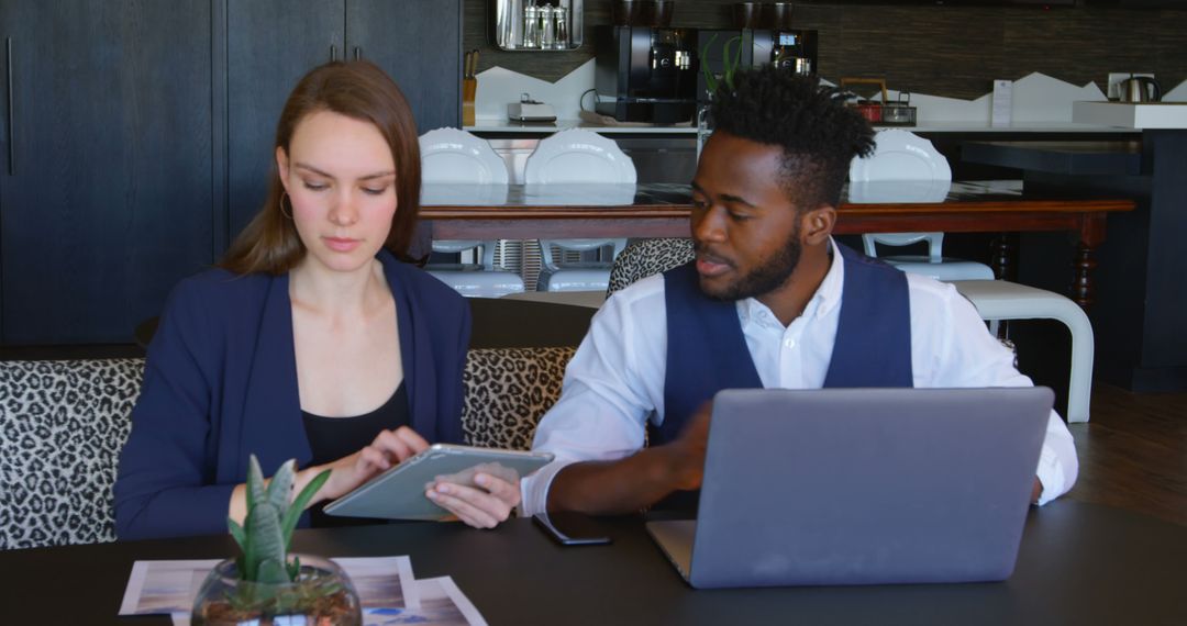 Young Professionals Collaborating on Digital Tablet in Modern Office