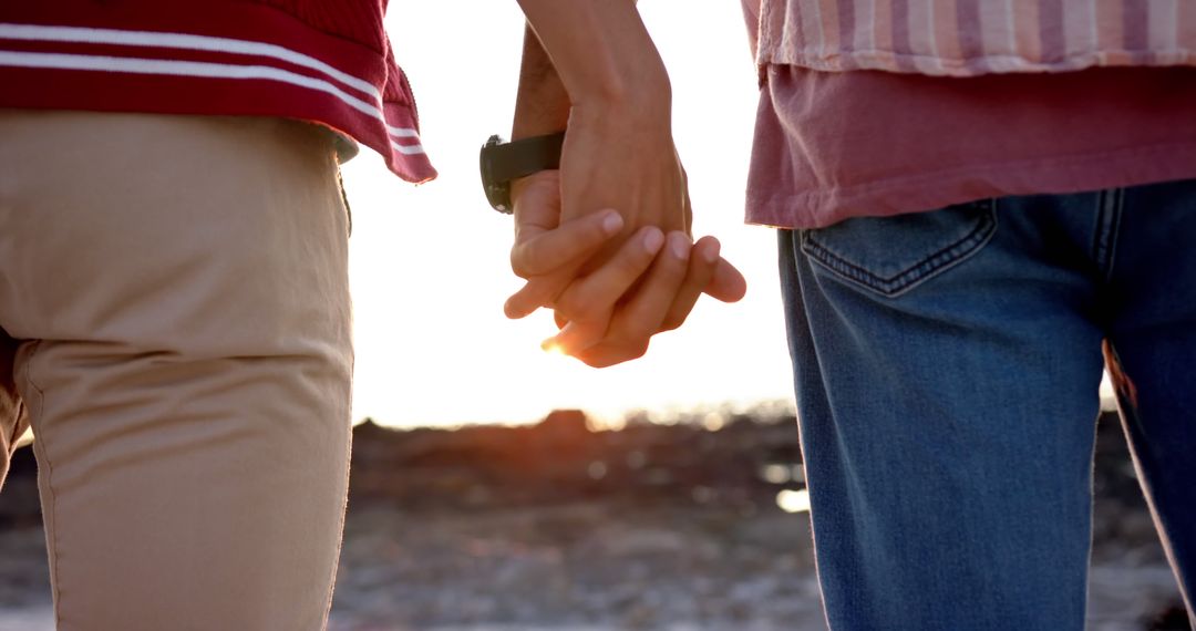 Diverse gay male couple standing and holding hands by the sea - Free Images, Stock Photos and Pictures on Pikwizard.com