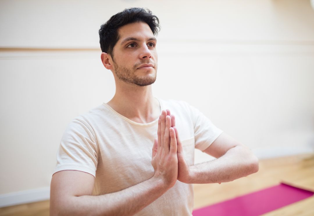 Man Practicing Mindful Yoga on Analogous Mat Background